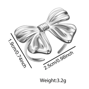 Elegant silver bow-shaped metal ring with textured surface details and dimension labels