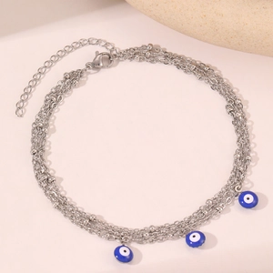Bohemian silver evil eye layered anklet with blue enamel charms and tassel detail