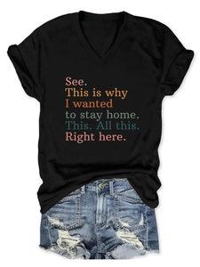 Flat lay of black V-neck t-shirt with colorful quote paired with distressed denim shorts