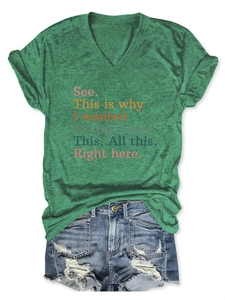 Flat lay of a grey V-neck t-shirt with slogan text and distressed denim shorts
