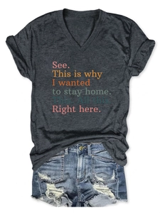 Flat lay of women's grey V-neck t-shirt with quotes and distressed denim shorts