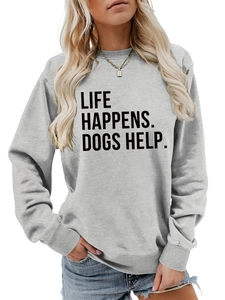 Detail of the Life Happens Dogs Help printed text on a light gray crewneck sweatshirt