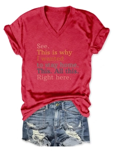 Flat lay of a red V-neck T-shirt with graphic print and blue ripped denim shorts