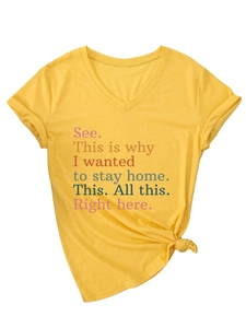 Detail of V-neck ginger yellow t-shirt with knotted hem and colorful slogan print