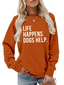 Close-up of orange crewneck sweatshirt with Life Happens Dogs Help white slogan print