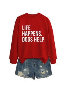 Close-up of red dog slogan sweatshirt paired with distressed denim shorts on white background