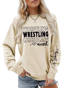 Detail of the letter print on the sleeve and chest of this beige wrestling aunt sweatshirt