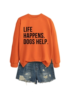 Detail of bright orange sweatshirt with Life Happens Dogs Help text and denim shorts