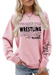 Detail of pink sweatshirt with WRESTLING print and slogan on the sleeve cuff
