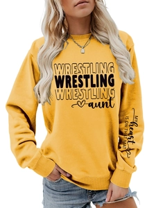 Close-up detail of yellow sweatshirt with WRESTLING print and sleeve text slogan