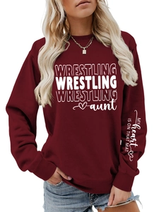 Detail of white text print on sleeve of a maroon wrestling aunt crewneck sweatshirt