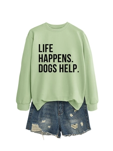 Detail of light green sweatshirt with Life Happens Dogs Help text and ripped denim shorts