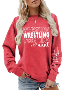 Detail of red sweatshirt showing the artistic print on the left sleeve and ribbed cuff