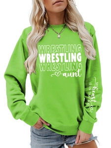 Close-up of white letter print on the sleeve of a vibrant green wrestling aunt sweatshirt