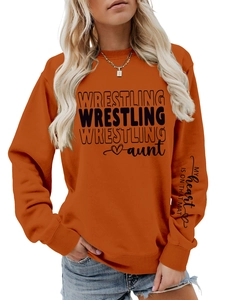 Detail of orange wrestling aunt sweatshirt showing sleeve heart print and ribbed cuffs