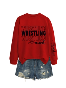 Detail of red sweatshirt sleeve with text My heart IS ON THAT MAT and ripped denim shorts