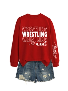Detailed view of red wrestling aunt sweatshirt sleeve with white graphic text on cuff