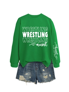 Detail view of green wrestling aunt sweatshirt with sleeve print and denim shorts set