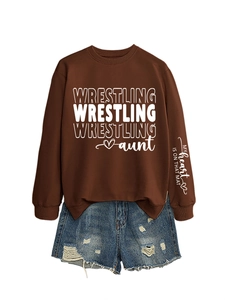 Detail of Women's Brown Wrestling Aunt Sweatshirt and Blue Distressed Denim Shorts