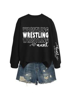 Detail of Wrestling Aunt sweatshirt with sleeve print and ripped denim shorts