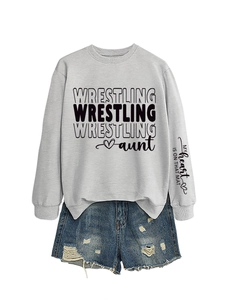 Detail of grey sweatshirt sleeve showing 'My heart is on that mat' text and ribbed cuff