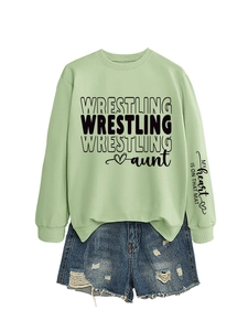 Detail of light green sweatshirt sleeve featuring My heart is on that mat printed text