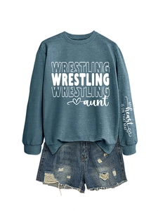 Flat lay of casual crewneck sweatshirt with sleeve print and ripped denim shorts