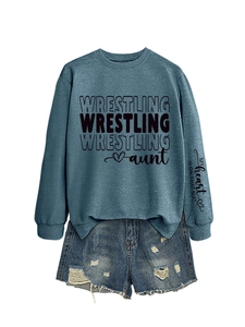 Flat lay of blue wrestling aunt sweatshirt with sleeve print and denim shorts set