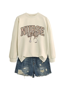 Détail du sweat-shirt infirmière avec nœud imprimé léopard et motif de stéthoscope