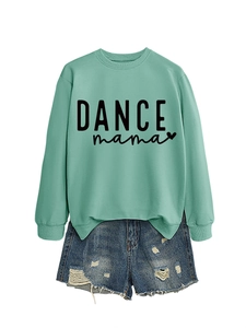 Close-up of mint green crewneck sweatshirt with black DANCE mama print and blue ripped denim shorts