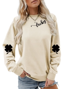 Detail of clover prints on sleeves and Lucky script on a beige long-sleeve sweatshirt
