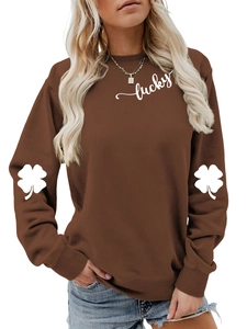 Detail of white lucky script and four-leaf clover print on casual brown sweatshirt