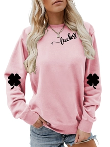 Detail of lucky text print and black clover pattern on pink long sleeve sweatshirt