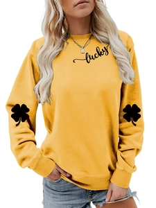 Detail of clover print on yellow sweatshirt sleeve with macro view of soft cotton texture