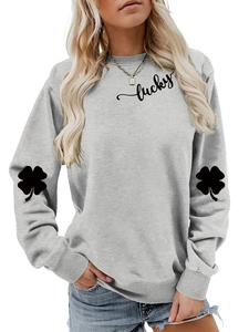 Detail of clover print on sleeve and lucky lettering on light grey sweatshirt