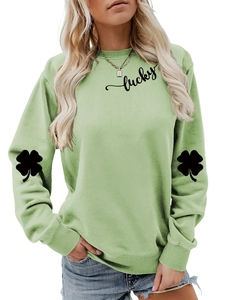 Detail view of lucky text and four-leaf clover sleeve print on light green sweatshirt