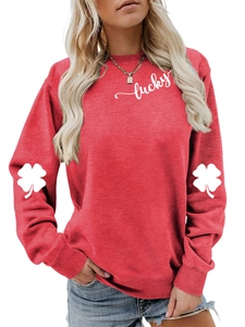 Detail of red crewneck sweatshirt featuring lucky text and clover arm prints