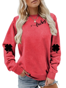 Detail of red sweatshirt showing black lucky text print and clover sleeve patterns