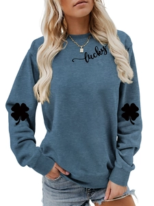 Detail of clover print on navy blue sweatshirt sleeve with lucky typography