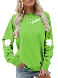 Close-up of lucky text and white clover patterns on fruit green crewneck sweatshirt