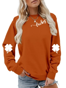 Detail of clover print on sleeves and lucky text on orange casual sweatshirt