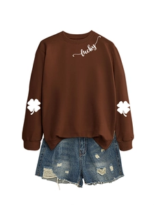 Detail of lucky text print and clover patterns on casual brown long sleeve sweatshirt