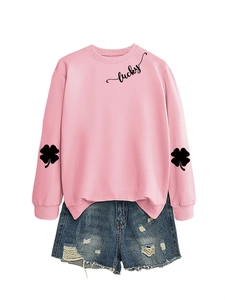 Detail of pink lucky sweatshirt and distressed denim shorts with clover sleeve prints