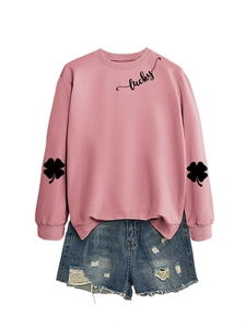 Pink sweatshirt detail with lucky script print and four-leaf clover sleeve graphics