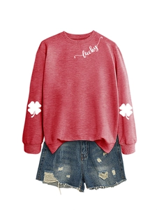 Detail of clover sleeve prints and white lucky text on a brick red crewneck sweatshirt
