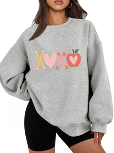 Close-up of grey sweatshirt featuring colorful pencil, heart, and crayon graphic design