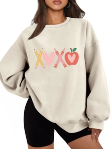 Detail of plush oatmeal sweatshirt featuring creative XOXO pencil and heart print