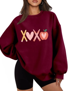 Macro detail of XOXO school-themed graphic print on burgundy plush fleece sweatshirt