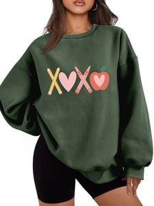 Detail of dark green sweatshirt featuring XOXO pencil and apple creative print