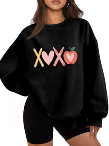Detail of a thick black sweatshirt featuring a cute XOXO school-themed graphic print